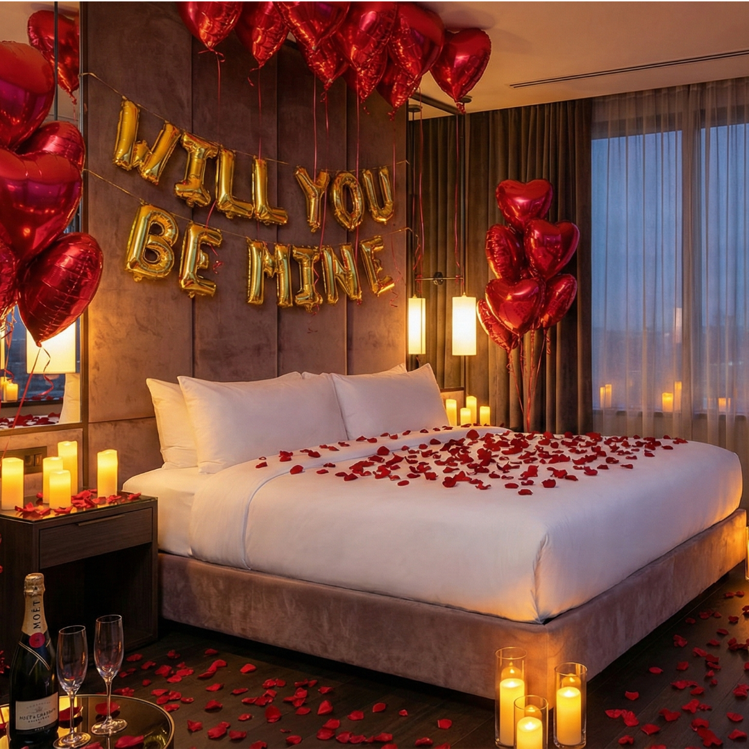 Romantic bedroom setup with 'WILL YOU BE MINE' balloons, candles, and rose petals.